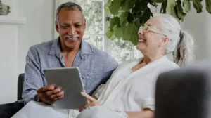 A man and woman viewing a tablet